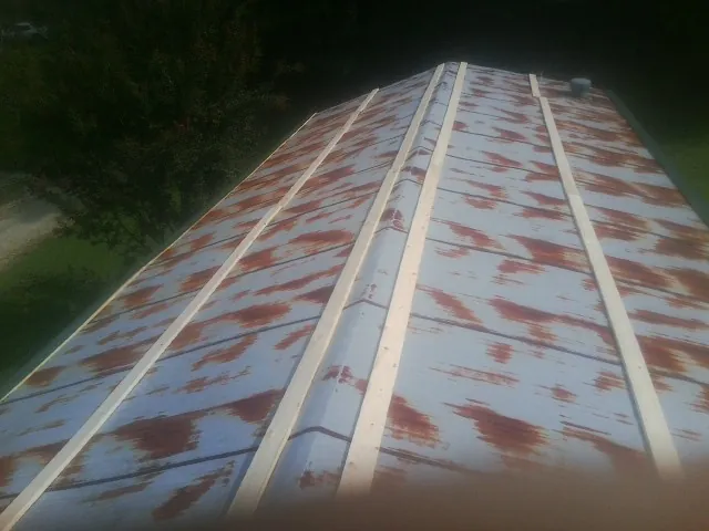 Rusted metal roof panels with new wood purlins before replacement — Storm Damage Roof Repair in Far Rockaway by Roofing Brothers