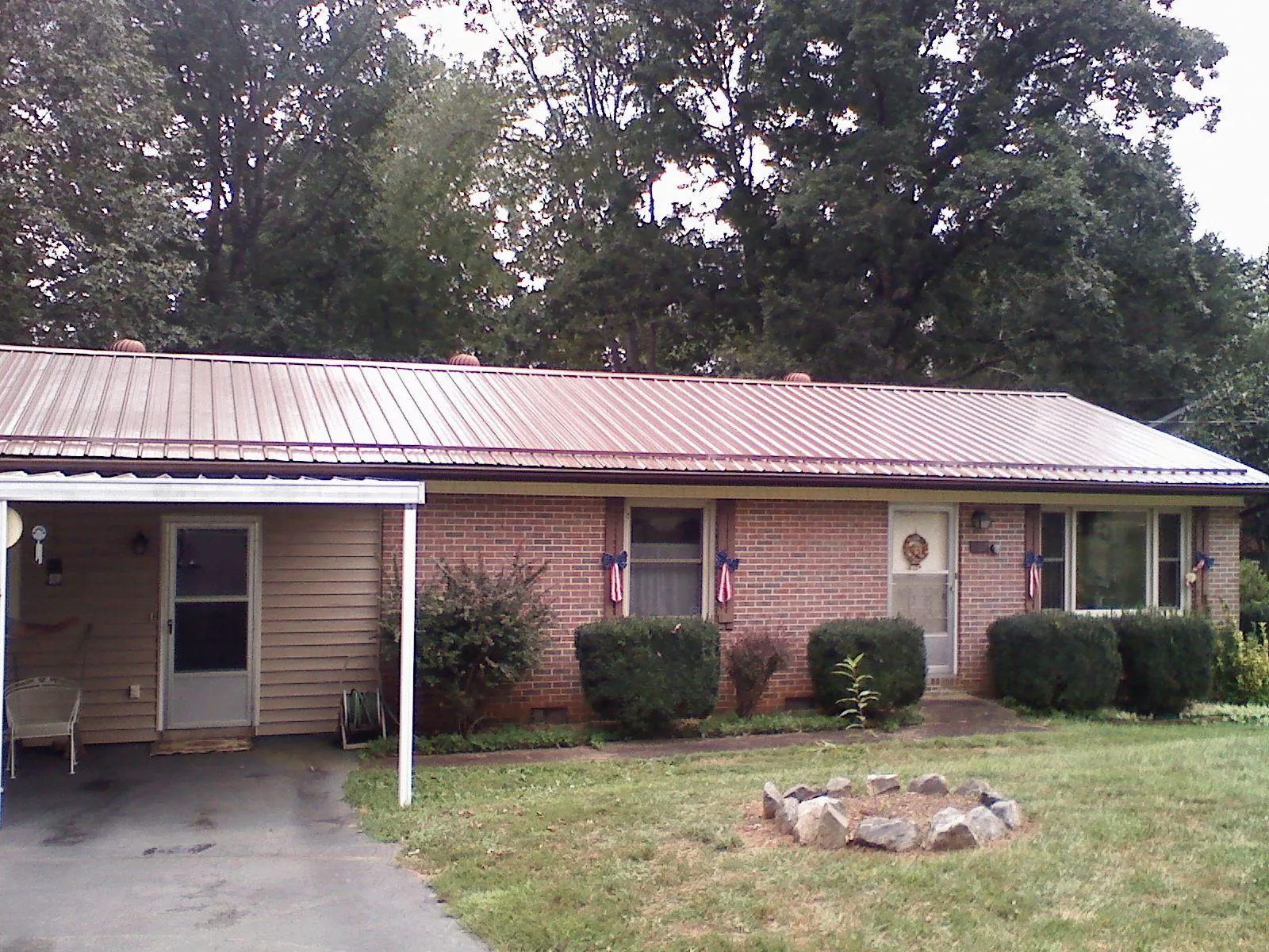 Bronze metal roof and carport on a brick ranch home — Roof Repair work by our crew in Far Rockaway