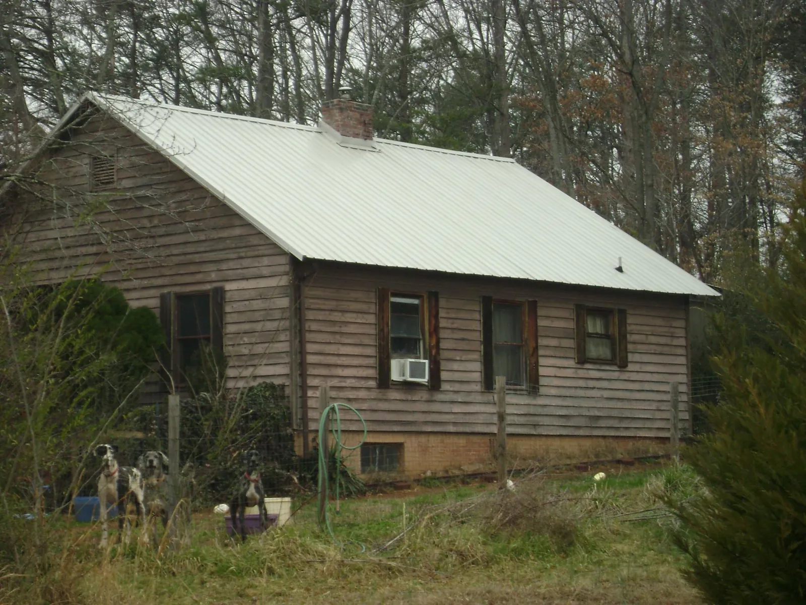 White metal roof on an old wood sided farmhouse, from a Metal Roof Installation job in Far Rockaway